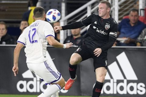 D.C. United forward Wayne Rooney, right, battles for the ball against Orlando City defender Shane O'Neill (12) during the first half of an MLS soccer match, Sunday, Aug. 12, 2018, in Washington. (AP Photo/Nick Wass)