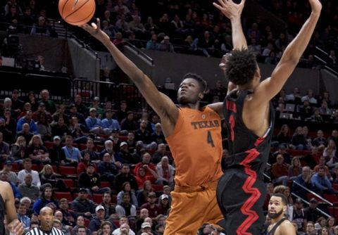 Texas forward Mohamed Bamba, left, shoots over Gonzaga forward Johnathan Williams during the second half of an NCAA college basketball game in the Phil Knight Invitational tournament in Portland, Ore., Sunday, Nov. 26, 2017. (AP Photo/Craig Mitchelldyer)