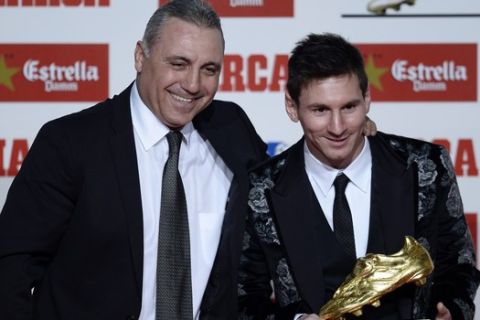Former soccer player Hristo Stoichkov from Bulgaria, left, poses for the media with Barcelona's Lionel Messi from Argentina after receiving the Golden Boot award for scoring the most goals in Europe's domestic leagues last season in Barcelona, Spain, Wednesday, Nov. 20, 2013. (AP Photo/Manu Fernandez)
