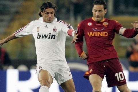 AS Roma strikerFrancesco Totti, right, and AC Milan defender Paolo Maldini fight for the ball during the Italian Serie A soccer match between AS Roma and AC Milan at Rome's Olympic stadium, Saturday, March 15, 2008. (AP Photo/Gregorio Borgia)