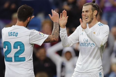 Real Madrid's Gareth Bale, right, celebrates with Isco after scoring his side's 2nd goal during a Spanish La Liga soccer match between Real Madrid and Celta at the Santiago Bernabeu stadium in Madrid, Spain, Saturday, May 12, 2018. (AP Photo/Paul White)