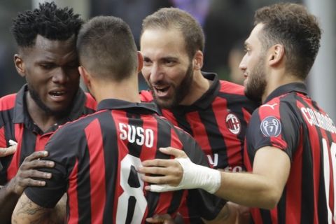 AC Milan's Gonzalo Higuain, second from right, celebrates with his teammates Hakan Calhanoglu, right, Suso and Franck Kessie, after scoring his side's opening goal during a Serie A soccer match between AC Milan and Atalanta, at the San Siro stadium in Milan, Italy, Sunday, Sept. 23, 2018. (AP Photo/Luca Bruno)