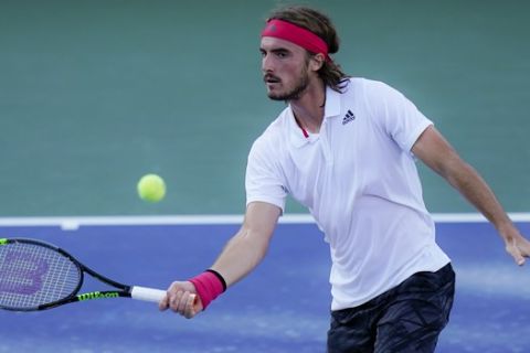 Stefanos Tsitsipas, of Greece, returns to Kevin Anderson, of South Africa, at the Western & Southern Open tennis tournament, Sunday, Aug. 23, 2020, in New York. (AP Photo/Frank Franklin II)