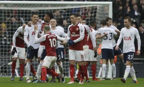 Arsenal's Jack Wilshere, (10), reacts to Tottenham Hotspur's Erik Lamela, second left just after the final whistle at the end of the English Premier League soccer match between Tottenham Hotspur and Arsenal at Wembley stadium in London, Saturday, Feb. 10, 2018. (AP Photo/Matt Dunham)