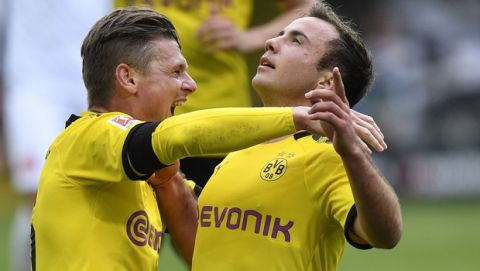 Dortmund's Mario Goetze, right, celebrates after scoring his side's third goal with Lukasz Piszczek, left, during the German Bundesliga soccer match between Borussia Dortmund and Fortuna Duesseldorf in Dortmund, Germany, Saturday, May 11, 2019. (AP Photo/Martin Meissner)