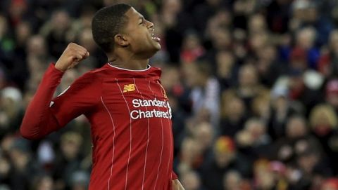 Liverpool's Rhian Brewster celebrates after scores during the penalty shootout during the English League Cup soccer match between Liverpool and Arsenal at Anfield stadium in Liverpool, England, Wednesday, Oct. 30, 2019. (AP Photo/Jon Super)