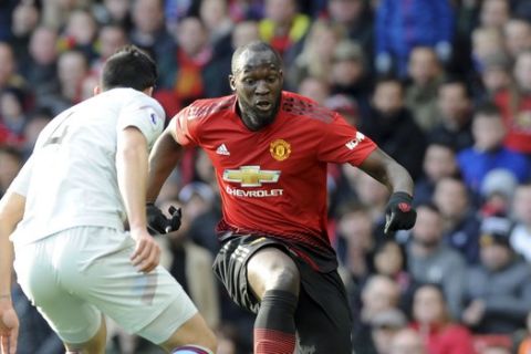 Manchester United's Romelu Lukaku vies for the ball with West Ham's Fabian Balbuena, left, during the English Premier League soccer match between Manchester United and West Ham United at Old Trafford in Manchester, England, Saturday, April 13, 2019. (AP Photo/Rui Vieira)