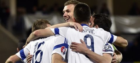 Bosnia and Herzegovina's forward  Edin Dzeko (C) celebrates with teammates after scoring a goal during the Euro Cup 2016 qualifying football match group D between Andorra and Bosnia and Herzegovina on March 28, 2015 at the Municipal Stadium in Andorra. AFP PHOTO / PASCAL PAVANI        (Photo credit should read PASCAL PAVANI/AFP/Getty Images)