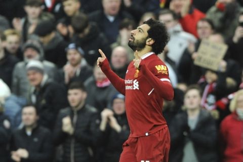 Liverpool's Mohamed Salah celebrates after scoring his side's first goal during the English Premier League soccer match between Liverpool and Tottenham Hotspur at Anfield in Liverpool, England, Sunday, Feb. 4, 2018. (AP Photo/Rui Vieira)