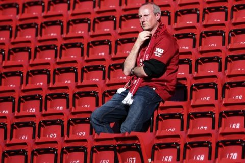 A Liverpool supporter looks from the stands at the end of the English Premier League soccer match between Liverpool and Wolverhampton Wanderers at the Anfield stadium in Liverpool, England, Sunday, May 12, 2019. Despite a 2-0 win over Wolverhampton Wanderers, Liverpool missed out on becoming English champion for the first time since 1990 because title rival Manchester City beat Brighton 4-1. (AP Photo/Dave Thompson)