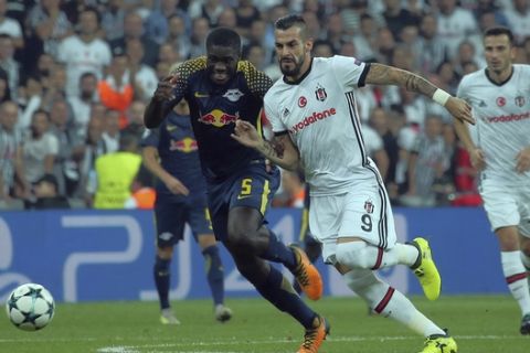 Besiktas' Alvaro Negredo, right, vies for the ball with RB Leipzig's Dayot Upamecano during the Champions League group G soccer match between Besiktas and RB Leipzig at the Vodafone Park Stadium in Istanbul, Tuesday, Sept. 26, 2017. (AP Photo)