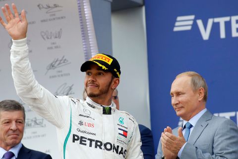 Mercedes driver Lewis Hamilton of Britain celebrates winning while Russian President Vladimir Putin, right, applauds after the Russian Formula One Grand Prix at the Sochi Autodrom circuit in Sochi, Russia, Sunday, Sept. 30, 2018.(AP Photo/Sergei Grits)