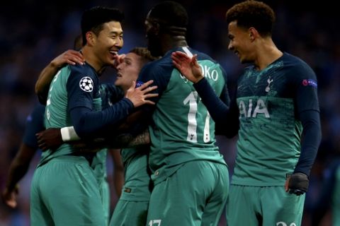 Tottenham's Son Heung-Min, left, celebrates scoring during the Champions League quarterfinal, second leg, soccer match between Manchester City and Tottenham Hotspur at the Etihad Stadium in Manchester, England, Wednesday, April 17, 2019. (AP Photo/Dave Thompson)