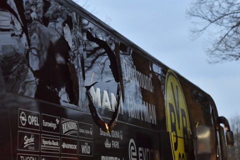 A window of Dortmund's team bus is damaged after an explosion before the Champions League quarterfinal soccer match between Borussia Dortmund and AS Monaco in Dortmund, western Germany, Tuesday, April 11, 2017.  (AP Photo/Martin Meissner)