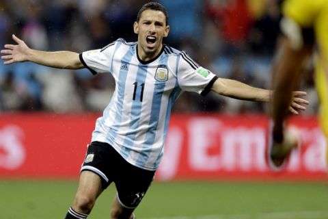 Argentina's Maxi Rodriguez celebrates after scoring the winning goal during a penalty shootout after extra time during the World Cup semifinal soccer match between the Netherlands and Argentina at the Itaquerao Stadium in Sao Paulo Brazil, Wednesday, July 9, 2014. Argentina defeated the Netherlands 4-2 in a penalty shootout after a 0-0 tie to advance to the finals. (AP Photo/Natacha Pisarenko)