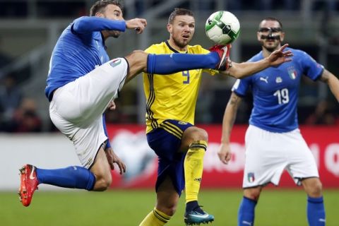 Italy's Andrea Barzagli, left, and Sweden's Marcus Berg vie for the ball during the World Cup qualifying play-off second leg soccer match between Italy and Sweden, at the Milan San Siro stadium, Italy, Monday, Nov. 13, 2017. (AP Photo/Antonio Calanni)