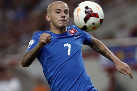 Slovakia's Vladimir Weiss tries to control the ball during a World Cup Group G qualifying soccer match against Greece at the Karaiskaki stadium in the port of Piraeus, near Athens, Friday, Oct. 11, 2013. (AP Photo/Kostas Tsironis)