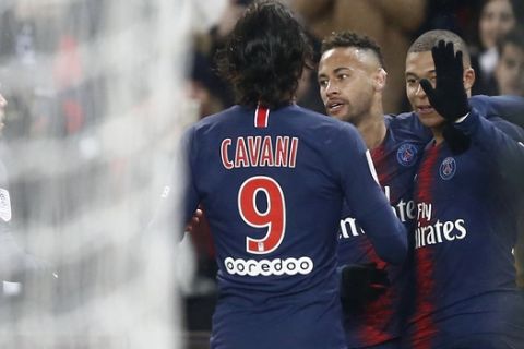 PSG's Kylian Mbappe, right, celebrates with Neymar, 2nd right, and Edinson Cavani after scoring his side's second goal during the League One soccer match between Paris Saint Germain and Guingamp at the Parc des Princes stadium in Paris, Saturday, Jan. 19, 2019. (AP Photo/Michel Euler)