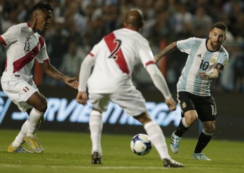 Argentina's Lionel Messi, right, fights for the ball with Peru's Alberto Rodriguez, center, and Renato Tapia during a World Cup qualifying soccer match at La Bombonera stadium in Buenos Aires, Argentina, Thursday, Oct. 5, 2017. (AP Photo/Victor R. Caivano)