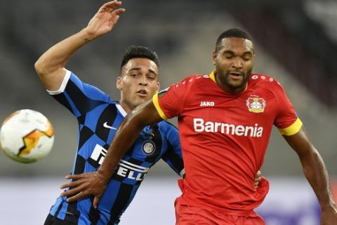 Inter Milan's Lautaro Martinez, left, challenges for the ball with Leverkusen's Jonathan Tah during the Europa League quarter finals soccer match between Inter Milan and Bayer Leverkusen at Duesseldorf Arena, in Duesseldorf, Germany, Monday, Aug. 10, 2020. (AP Photo/Martin Meissner)