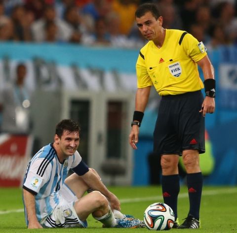 RIO DE JANEIRO, BRAZIL - JUNE 15:  Lionel Messi of Argentina lies on the field as referee Joel Aguilar stands over him after a foul during the 2014 FIFA World Cup Brazil Group F match between Argentina and Bosnia-Herzegovina at Maracana on June 15, 2014 in Rio de Janeiro, Brazil.  (Photo by Jamie Squire/Getty Images)