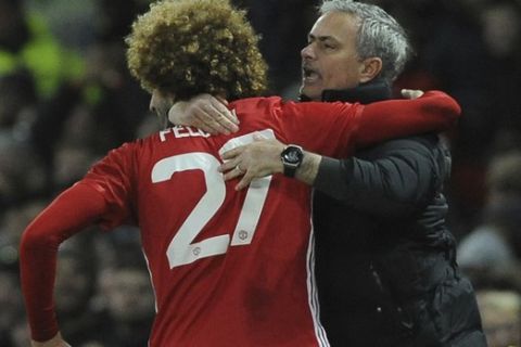 Manchester United's manager Jose Mourinho, right, hugs his player Manchester United's Marouane Fellaini after he scored his sides second goal of the game during the English League Cup semifinal, 1st leg, soccer match between Manchester United and Hull at Old Trafford stadium in Manchester, England, Tuesday, Jan. 10, 2017. (AP Photo/Rui Vieira)