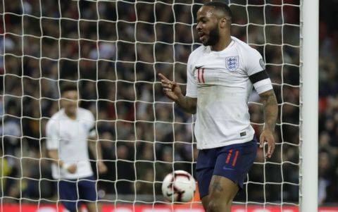 England's Raheem Sterling, center, celebrates the opening goal against Czech Republic during the Euro 2020 group a qualifying soccer match between England and the Czech Republic at Wembley stadium in London, Friday March 22, 2019. (AP Photo/Matt Dunham)