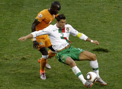 Portugal's Cristiano Ronaldo, right, controls the ball next to Ivory Coast's Cheick Tiote, left, during the World Cup group G soccer match between Ivory Coast and Portugal at Nelson Mandela Bay Stadium in Port Elizabeth, South Africa, Tuesday, June 15, 2010.  (AP Photo/Yves Logghe)