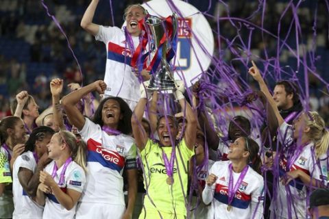 Lyon's goalkeeper Sarah Bouhaddi lifts the trophy after the Women's Champions League Final soccer match at the Cardiff City Stadium in Cardiff, Wales, Thursday, June 1, 2017. (Nick Potts/PA via AP)
