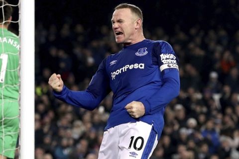 Everton's Wayne Rooney celebrates scoring his side's third goal of the game from the penalty spot during their English Premier League soccer match Everton versus Swansea City at Goodison Park, Liverpool, England, Monday, Dec. 18, 2017. (Martin Rickett/PA via AP)