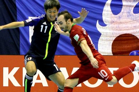 Kazuyoshi Miura of Japan, left, fights for the ball with Ricardinho of Portugal during the FIFA futsal World Cup first round match in Nakhon Ratchasima province, northeastern Thailand Sunday, Nov. 4, 2012. (AP Photo/Apichart Weerawong)