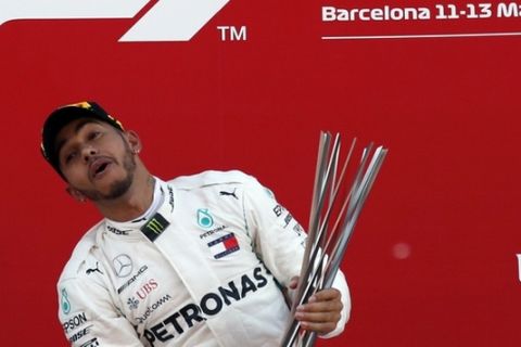 Mercedes driver Lewis Hamilton of Britain celebrates on the podium after winning the Spanish Formula One Grand Prix at the Barcelona Catalunya racetrack in Montmelo, Spain, Sunday, May 13, 2018. (AP Photo/Manu Fernandez)