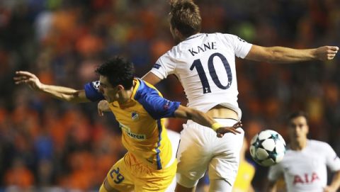 APOEL's Praksitelis Vouros, left, challenges for the ball with Tottenham's Harry Kane during the Champions League Group H soccer match between APOEL Nicosia and Tottenham Hotspur at GSP stadium, in Nicosia, Cyprus, on Tuesday, Sept. 26, 2017. (AP Photo/Petros Karadjias)