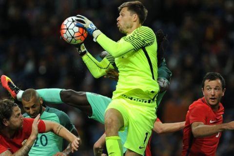 Norway's goalkeeper Rune Jarstein grabs the ball over Portugal's Ricardo Quaresma, second left, and Danilo Pereira during a friendly soccer match between Portugal and Norway at the Dragao stadium in Porto, Portugal, Sunday, May 29, 2016. The Portuguese squad is in preparation for the UEFA EURO 2016 soccer championships, hosted by France. Portugal won 3-0.(AP Photo/Paulo Duarte)