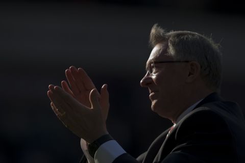 Manchester United manager Sir Alex Ferguson, center, applauds supporters after his last game in charge of his team, their English Premier League soccer match against West Bromwich Albion at The Hawthorns Stadium, West Bromwich, England, Sunday May 19, 2013. (AP Photo/Jon Super)  