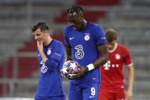 Chelsea's Tammy Abraham carries the ball after scoring his team's first goal during the Champions League round of 16 second leg soccer match between Bayern Munich and Chelsea at Allianz Arena in Munich, Germany, Saturday, Aug. 8, 2020. (AP Photo/Matthias Schrader)