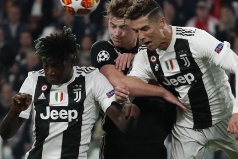 Juventus' Cristiano Ronaldo, right, Ajax's Matthijs de Ligt, center, and Juventus' Moise Kean fight for the ball during the Champions League quarter final, second leg soccer match between Juventus and Ajax, at the Allianz stadium in Turin, Italy, Tuesday, April 16, 2019. (AP Photo/Antonio Calanni)