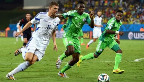 CUIABA, BRAZIL - JUNE 21:  Edin Dzeko of Bosnia and Herzegovina and Kenneth Omeruo of Nigeria compete for the ball during the 2014 FIFA World Cup Group F match between Nigeria and Bosnia-Herzegovina at Arena Pantanal on June 21, 2014 in Cuiaba, Brazil.  (Photo by Stu Forster/Getty Images)