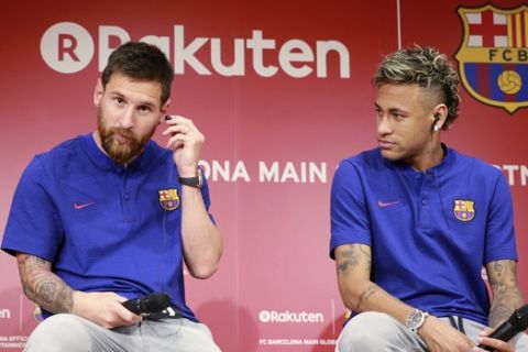 FC Barcelona's Lionel Messi, left, and Neymar attend a press conference in Tokyo Thursday, July 13, 2017. They are in the city to introduce Japanese online retailer Rakuten as the main global sponsor of the soccer club. (AP Photo/Eugene Hoshiko)