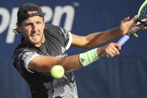 Lucas Pouille, of France, returns a shot to Philipp Kohlschreiber, of Germany, during the first round of the US Open tennis tournament Monday, Aug. 26, 2019, in New York. (AP Photo/Michael Owens)