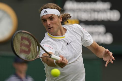 Greece's Stefanos Tsitsipas returns the ball to Switzerland's Alexander Ritschard during their singles tennis match on day two of the Wimbledon tennis championships in London, Tuesday, June 28, 2022. (AP Photo/Alastair Grant)