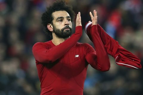Liverpool forward Mohamed Salah, right, applauds after his team won the Champions League Group C soccer match between Liverpool and Napoli at Anfield stadium in Liverpool, England, Tuesday, Dec. 11, 2018.(AP Photo/Dave Thompson)