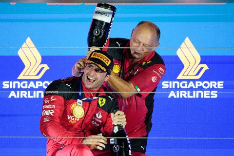 Ferrari driver Carlos Sainz of Spain reacts as a teammate pours champagne over him as he celebrates on the podium after winning the Singapore Formula One Grand Prix at the Marina Bay circuit, Singapore,Sunday, Sept. 17, 2023. (AP Photo/Vincent Thian)