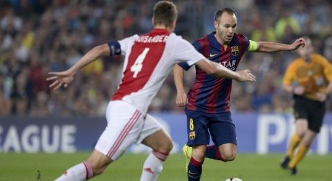 Ajax Amsterdam's Finish defender Niklas Moisander (L) vies with Barcelona's midfielder Andres Iniesta during the UEFA Champions League football match FC Barcelona vs Ajax Amsterdam at the Camp Nou stadium in Barcelona on October 21, 2014.   AFP PHOTO/ JOSEP LAGO        (Photo credit should read JOSEP LAGO/AFP/Getty Images)