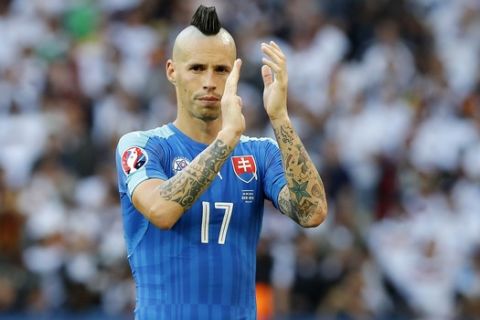 Slovakia's Marek Hamsik salutes fans at the end of the Euro 2016 round of 16 soccer match between Germany and Slovakia, at the Pierre Mauroy stadium in Villeneuve d'Ascq, near Lille, France, Sunday, June 26, 2016. (AP Photo/ Michel Spingler)