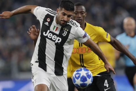 Juventus midfielder Emre Can, left, and Young Boys' Mohamed Ali Camara vie for the ball during the Champions League, group H soccer match between Juventus and Young Boys, at the Allianz stadium in Turin, Italy, Tuesday, Oct. 2, 2018. (AP Photo/Luca Bruno)