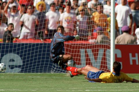 LOS ANGELES, UNITED STATES:  Colombian defender Andres Escobar lies on the ground after scoring an own goal past goalkeeper Oscar Cordoba while trying to stop a shot from US forward John Harkes during the World Cup first round soccer match between the United States and Colombia 22 June 1994 in Los Angeles. The United States beat Colombia 2-1. AFP PHOTO/ROMEO GACAD (Photo credit should read ROMEO GACAD/AFP/Getty Images)