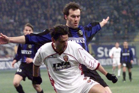 AS Roma striker Vincenzo Montella, front, is tackled by Inter Milan's defender Laurent Blanc of France, during their Italian first division soccer match at Milan's  San Siro stadium in Italy, Sunday, Jan. 30, 2000. (AP Photo/Felice Calabro')