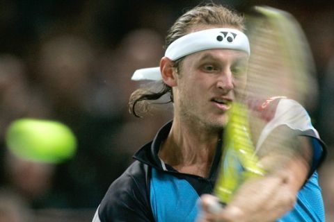 David Nalbandian of Argentina plays a return to Spain's Rafael Nadal during the final of the Paris Tennis Masters tournament, Sunday, Nov. 4, 2007. (AP Photo/Lionel Cironneau)