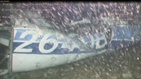 In this image released Monday Feb. 4, 2019, by the UK Air Accidents Investigation Branch (AAIB) showing the rear left side of the fuselage including part of the aircraft registration N264DB that went missing carrying soccer player Emiliano Sala, when it disappeared from radar contact on Jan. 21 2019.  The Air accident investigators say one body is visible in the sea in the wreckage of the plane that went missing carrying soccer player Emiliano Sala and his pilot David Ibbotson. (AAIB via AP)